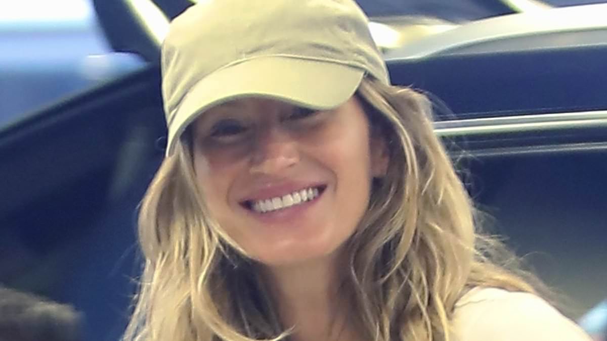 alert-–-gisele-bundchen,-43,-flashes-her-megawatt-smile-while-in-all-white-outfit-at-a-miami-airport…-one-year-after-tom-brady-divorce