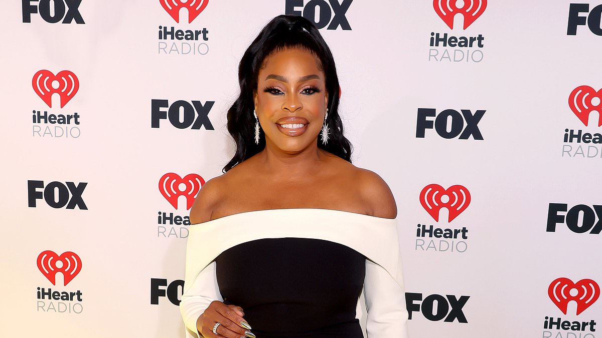 alert-–-iheartradio-music-awards: niecy-nash-betts-wows-in-monochromatic-jumpsuit-as-she-holds-hands-with-wife-jessica-betts-before-presenting-best-new-artist