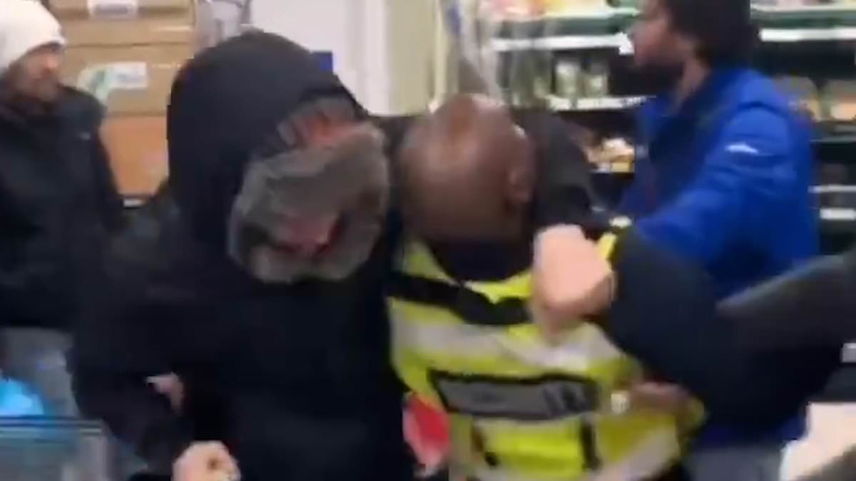 alert-–-moment-shoplifter-with-bag-of-stolen-goods-fights-with-tesco-security-guard-and-puts-him-in-a-headlock-as-he-tries-to-stop-him-from-fleeing-store