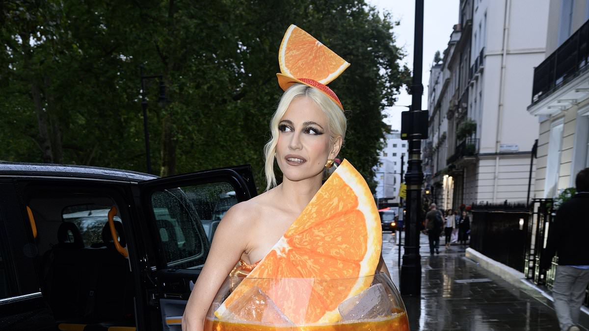 alert-–-pixie-lott-goes-all-out-for-halloween-by-dressing-up-as-an-aperol-spritz-as-she-arrives-at-exclusive-mayfair-members-club-for-lavish-bash