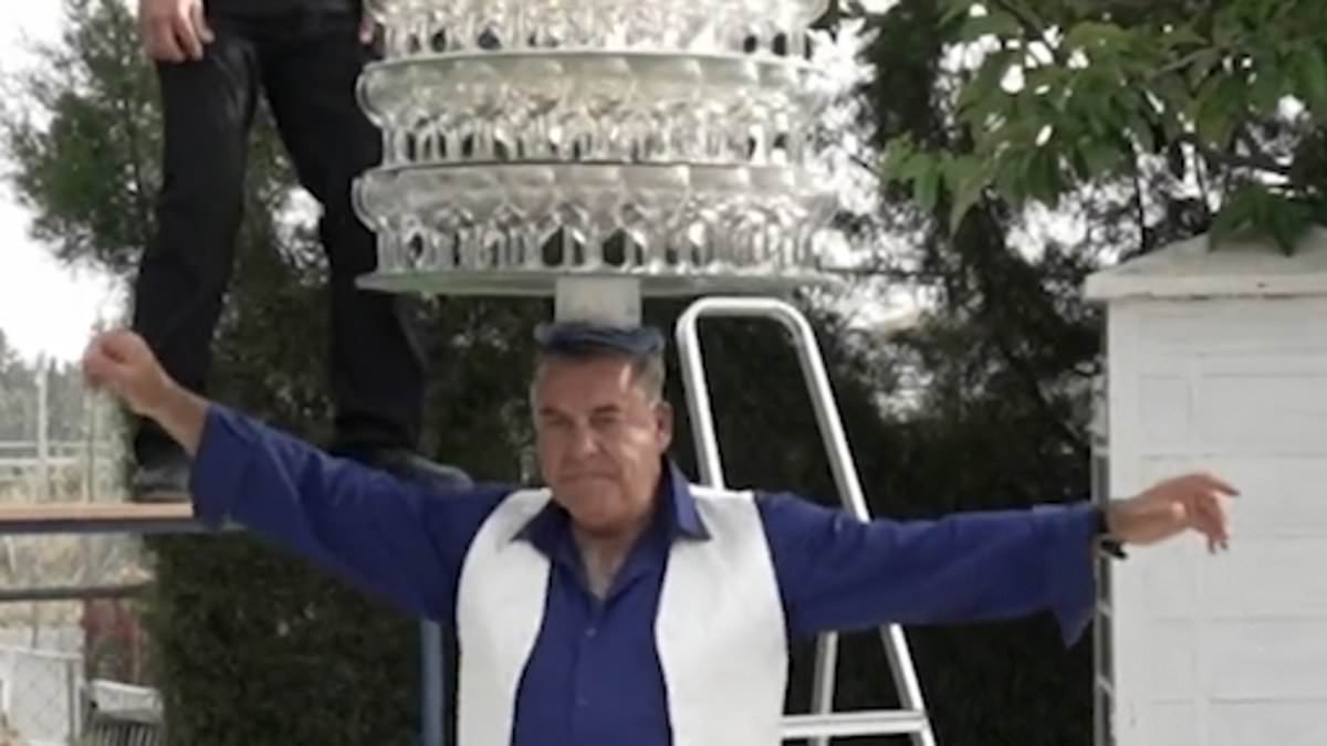 alert-–-man-smashes-record-for-most-wine-glasses-balanced-on-the-head-with-319-stacked-on-nine-trays…-before-they-all-come-crashing-down