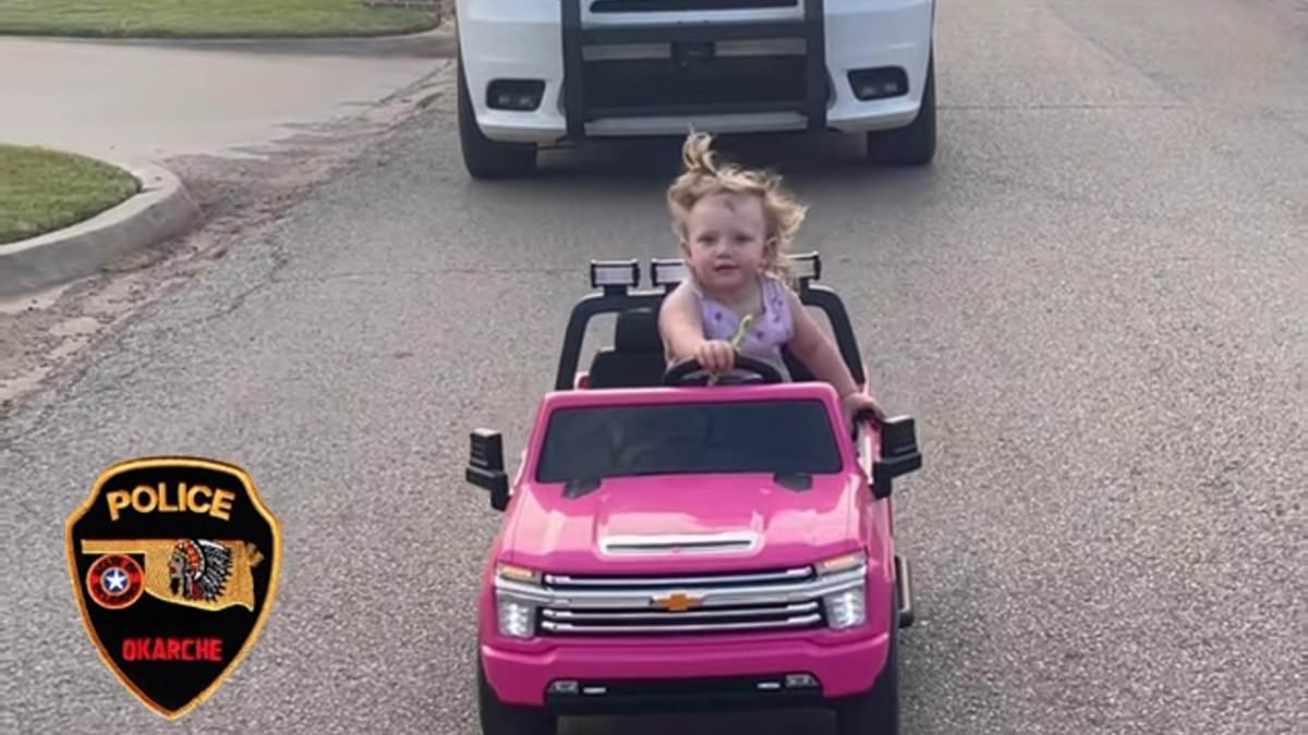 alert-–-hilarious-moment-toddler-driving-a-bright-pink-toy-car-is-pulled-over-by-cops-for-‘exceeding-the-speed-limit’-and-brushing-her-teeth-at-the-wheel