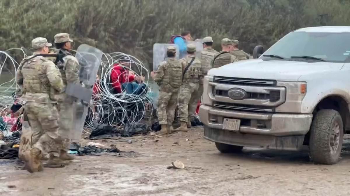 alert-–-texas-national-guards-use-riot-shields-to-hold-back-horde-of-migrants-trying-to-cross-through-razor-wire-in-eagle-pass-with-one-person-hurling-a-rock-towards-a-soldier’s-head