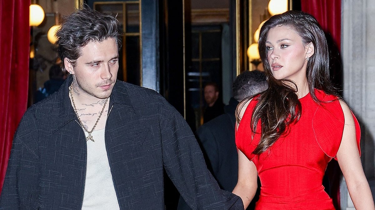 alert-–-nicola-peltz-stuns-in-bright-red-mini-dress-as-she-heads-hand-in-hand-with-husband-brooklyn-beckham-to-his-mother-victoria’s-paris-fashion-week-show-after speculation-actress-would-walk-the-runway-at-event