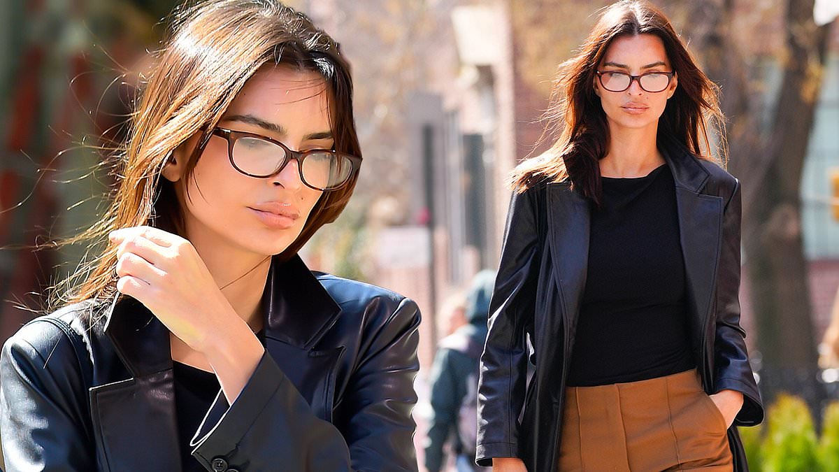 alert-–-emily-ratajkowski-looks-ready-for-a-business-meeting-in-a-leather-coat-with-tan-bell-bottom-trousers-as-she-adds-chic-eyeglasses-in-nyc