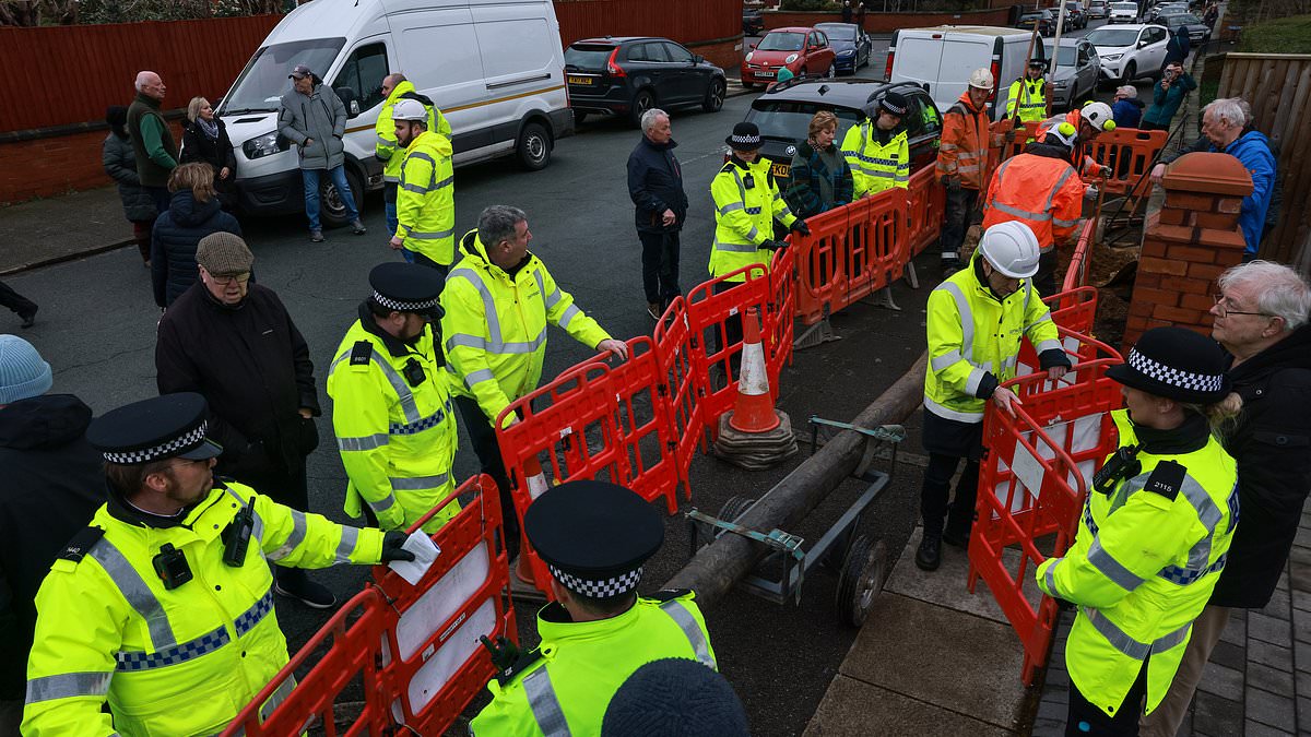 alert-–-police-are-called-in-as-furious-protesters-block-road-to-stop-hated-new-broadband-telegraph-poles-being-put-up-in-their-street