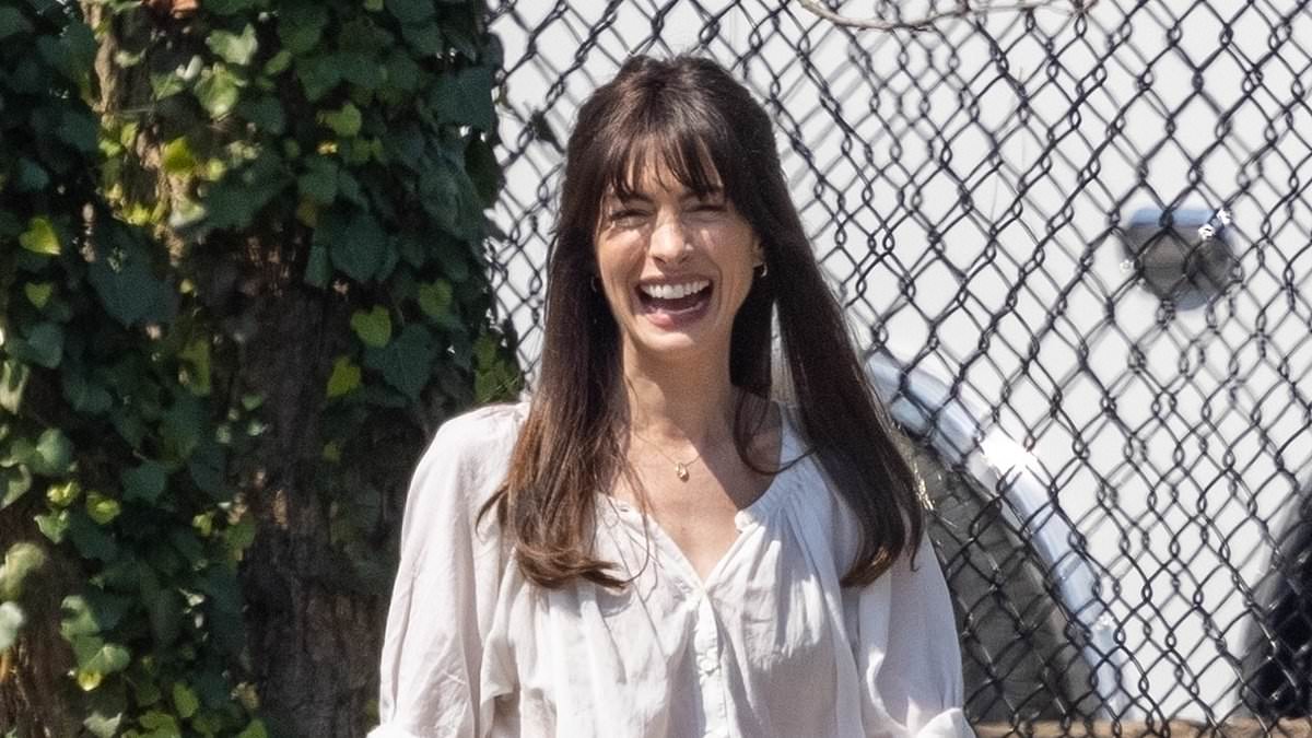 alert-–-anne-hathaway-beams-with-happiness-as-she-films-flowervale-street-in-summery-white-blouse-and-fitted-jeans-–-after-attending-sxsw