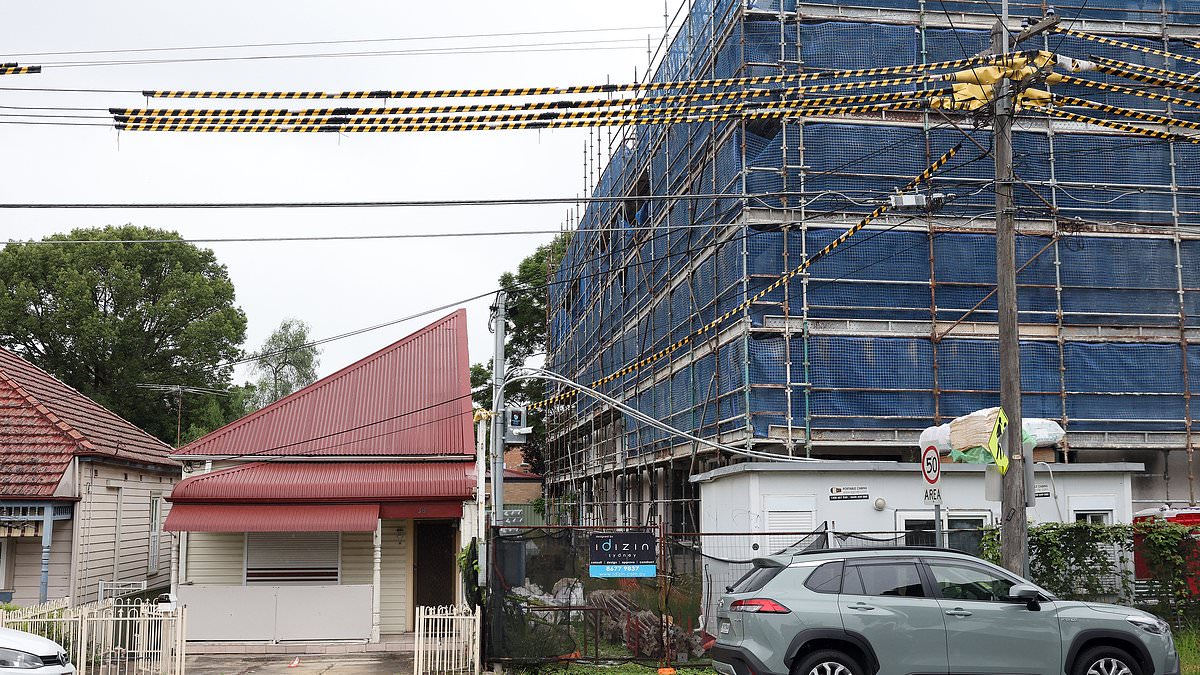 alert-–-auburn:-incredible-story-of-the-suburban-sydney-home-that’s-been-cut-in-half-by-a-six-storey-apartment-building-–-and-the-defiant-owner’s-ultimatum-to-property-developers