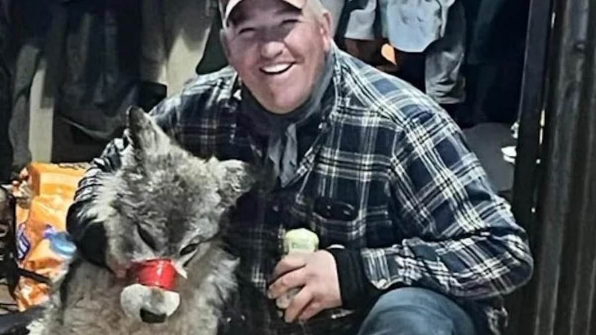 alert-–-wyoming-hunter,-42,-poses-with-exhausted-wolf-he-tortured-and-paraded-around-his-local-bar-with-its-mouth-taped-shut-before-shooting-it-dead-–-as-his-family-member-reenacts-the-sick-scene