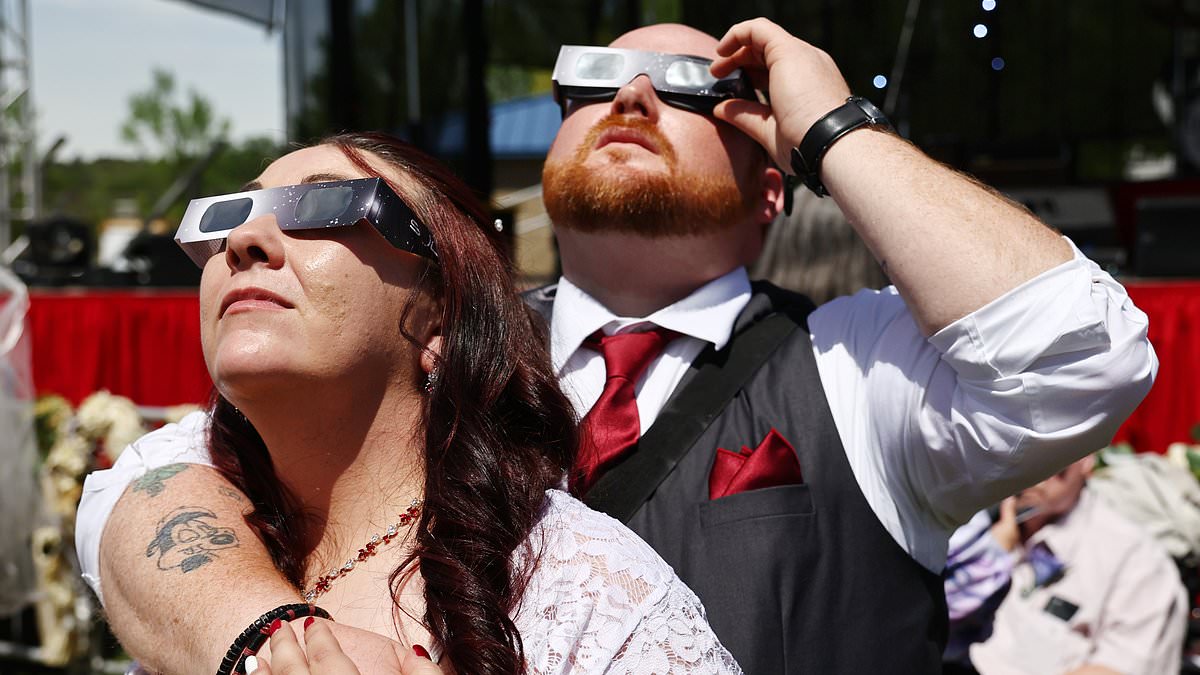 alert-–-more-than-four-hundred-couples-from-24-states-flock-to-football-field-to-get-hitched-at-exact-moment-the-moon-blocks-sun-during-solar-eclipse