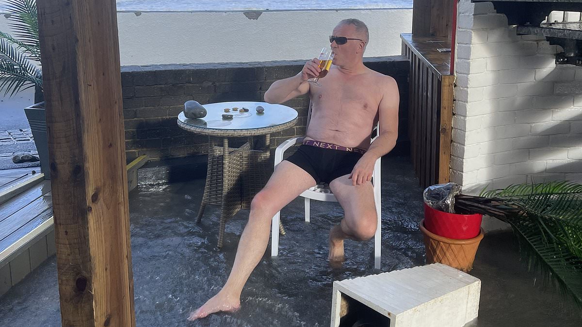 alert-–-devon-landlord-takes-‘most-british-photo-ever’-as-storm-pierrick-flooding-submerges-his-seaside-pub-turning-his-beer-garden-into-a-‘swim-up-bar’