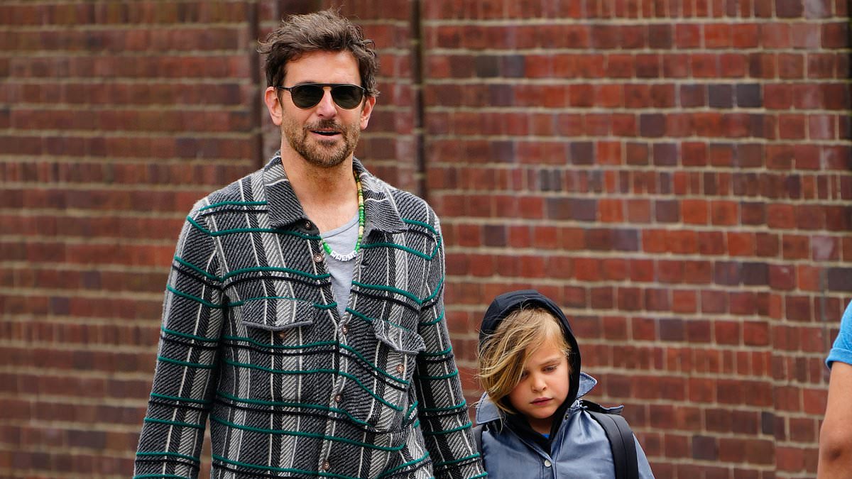 alert-–-bradley-cooper-wears-a-beaded-necklace-that-reads-magic-as-he-holds-hands-with-daughter-lea,-7,-in-new-york-city