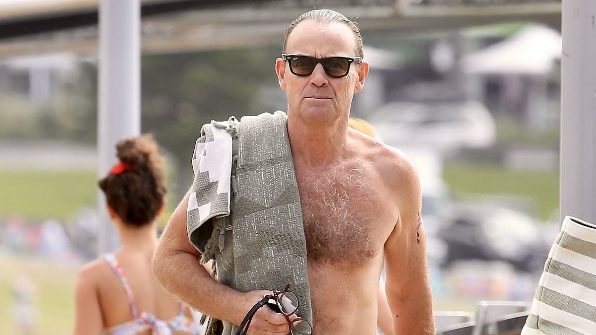 alert-–-neighbours-icon-jason-donovan,-55, -shows-off-his-toned-physique-in-a-pair-of-cheeky-budgie-smugglers-at-his-bondi-beach-swim-club