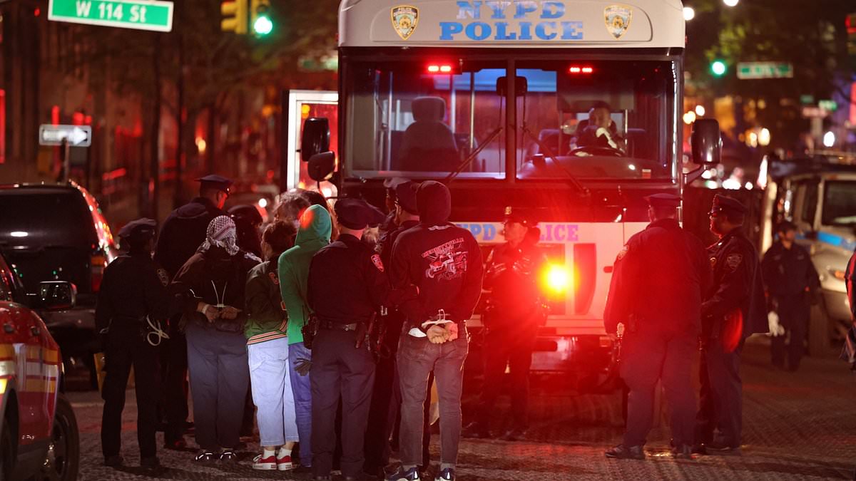 alert-–-arrested-protestors-who-stormed-campus-building-in-face-coverings-are-marched-bare-faced-onto-nypd-bus-and-driven-past-cheering-locals