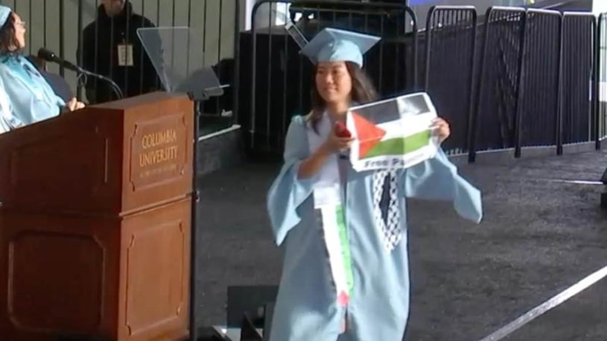 alert-–-columbia-university-students-rip-up-diplomas-on-stage-during-commencement-while-wearing-zip-ties-and-holding-palestine-flags