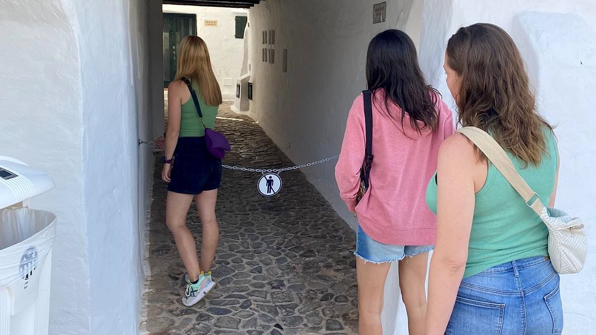 alert-–-holidaymakers-locked-out:-menorca-resort-shuts-out-sightseers-with-chains-across-its-picturesque-alleyways-which-attract-800,000-visitors-a-year-to-the-village-of-500-people-in-latest-anti-tourist-move