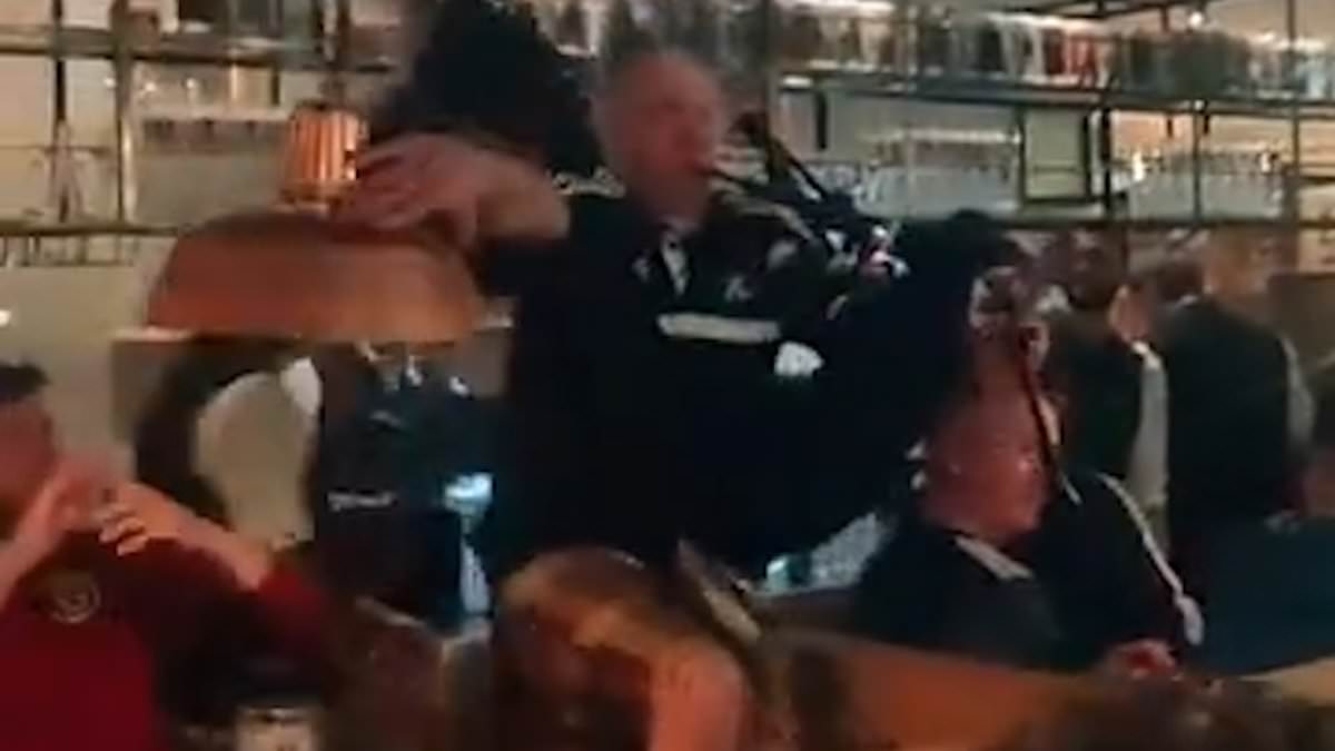 alert-–-tartan-army’s-munich-invasion:-hilarious-moment-bagpiper-falls-off-table-while-serenading-packed-bar-as-kilted-scotland-supporters-descend-on-city-to-down-steins-and-sing-in-the-streets-–-after-glasgow-airport-ran-out-of-tennent’s-lager-at-9am