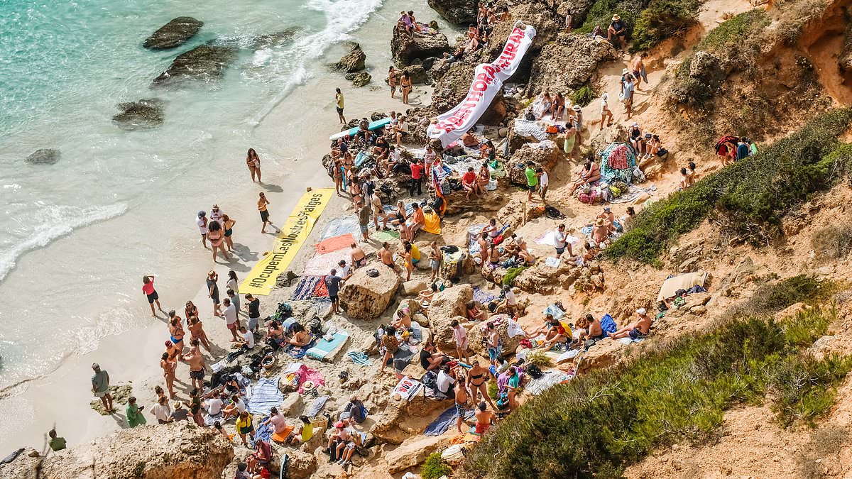 alert-–-jeering-majorcans-block-tourists-from-reaching-instagram-famous-beach-and-shout-‘go,-go,-go’-in-tense-stand-off-at-beauty-spot-amid-mass-protests-on-island-‘overwhelmed-by-holidaymakers’