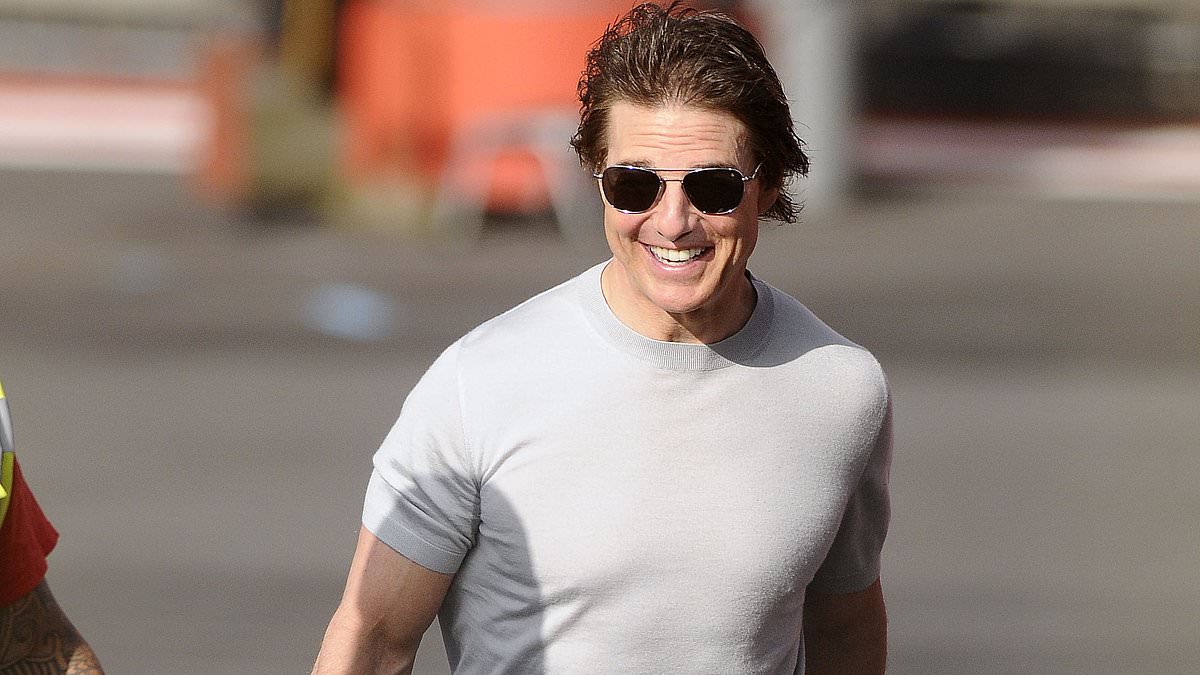 alert-–-tom-cruise-cuts-a-casual-figure-in-a-grey-t-shirt-and-jeans-as-he-lands-his-helicopter-at-battersea-helipad-and-gives-the-ground-crew-a-fist-bump