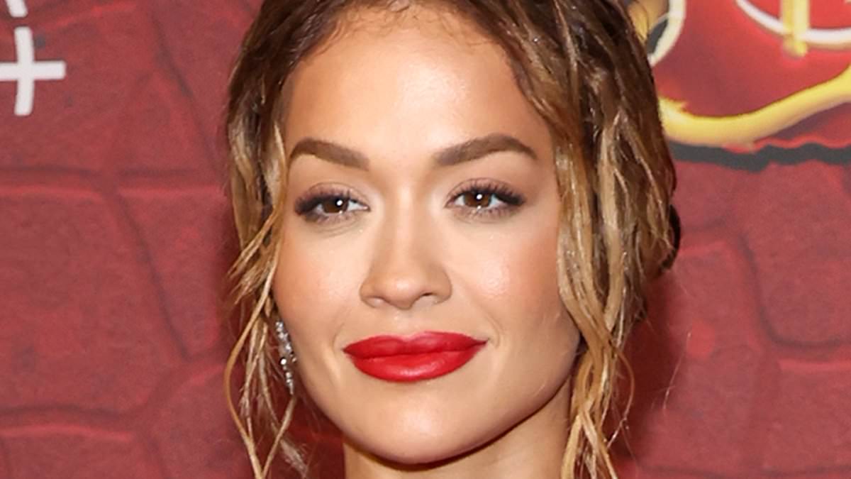 alert-–-rita-ora-is-red-hot-in-fiery-gown-with-a-sizzling-thigh-high-slit-as-she-leads-the-glamour-at disney’s-premiere-of descendants:-the-rise-of-red-in-la