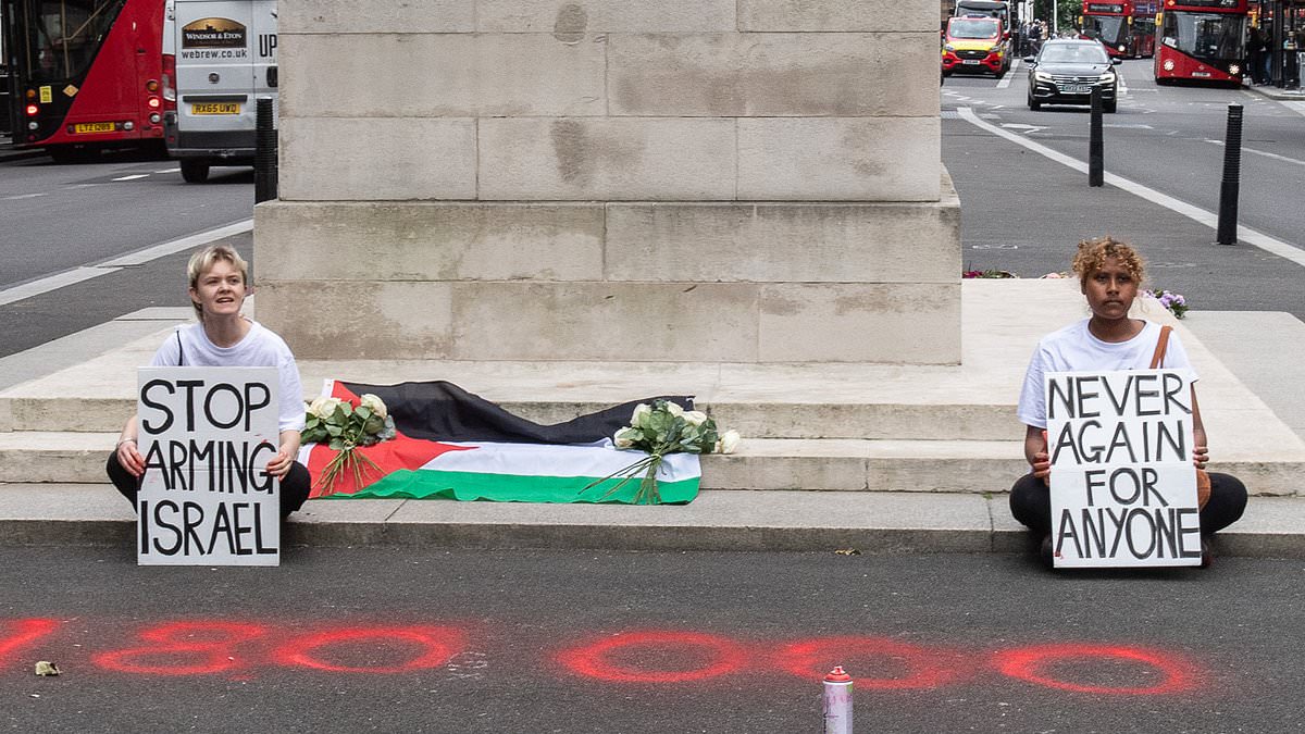 alert-–-anti-israel-activists-lay-a-palestine-flag-on-the-cenotaph-in-london-and-spray-paint-‘180,000-killed’-next-to-it-in-latest-protest:-police-arrest-two-women-on-suspicion-of-criminal-damage