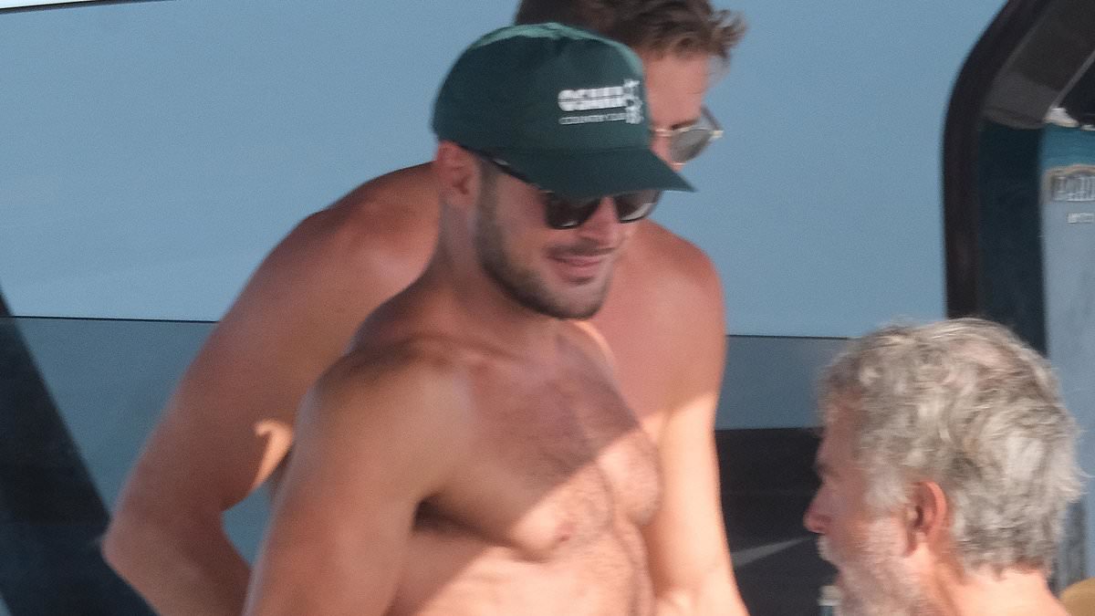 alert-–-zac-efron-bares-his-chiseled-chest-and-brawny-arms-as-he-goes-shirtless-on-a-yacht with-friends-in-ibiza