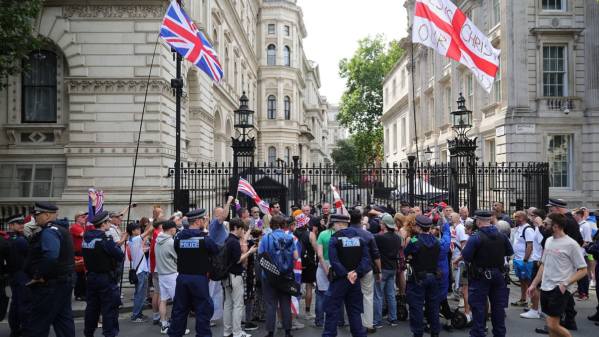 alert-–-flag-waving-tommy-robinson-protesters-chant-‘release-tommy-now’-outside-downing-street-after-‘arrest-under-anti-terror-laws’