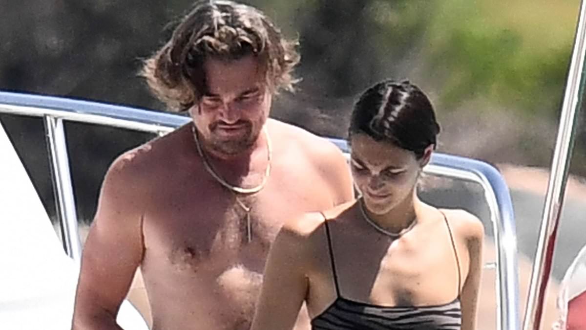 alert-–-leonardo-dicaprio,-49,-shows-off-his-buff-physique-with-bikini-clad-girlfriend-vittoria-ceretti,-26,-as-they-soak-up-the-sun-in-sardinia…-after-model-flashes-diamond-ring-on-that-finger