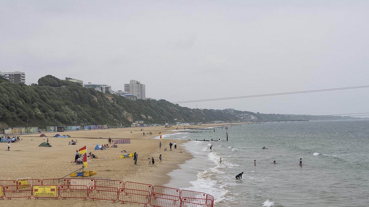 alert-–-what-a-difference-a-week-makes!-grey-skies-over-bournemouth-beach-fail-to-attract-crowds-just-seven-days-after-sunseekers-soaked-up-34.8c-heat-–-as-heavy-downpours-and-60mph-gusts-forecast