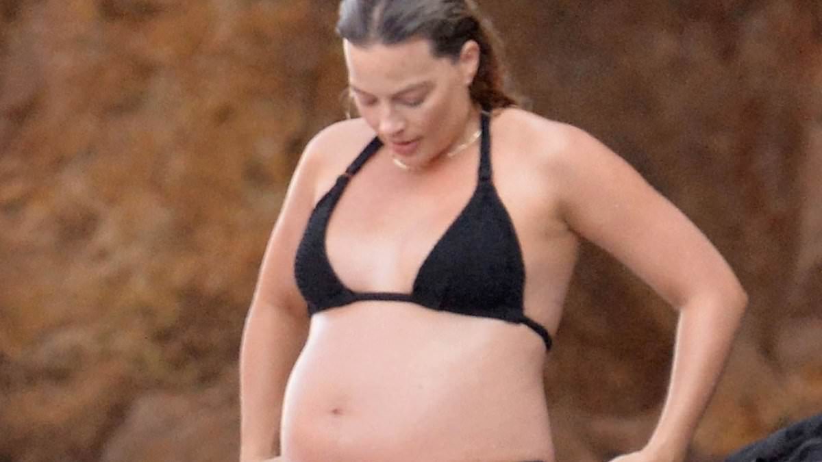 alert-–-pregnant-margot-robbie-showcases-her-growing-baby-bump-in-a-black-bikini-while-relaxing-with husband-tom-ackerley-during-sun-soaked-break-to-italy