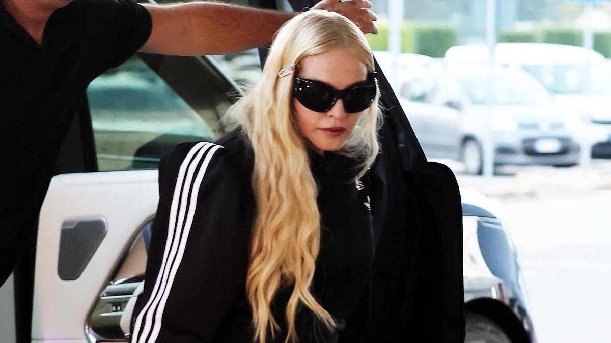 alert-–-madonna,-66,-puts-on-a-very-leggy-display-in-thigh-high-socks-and-black-mini-skirt-as-she-departs-milan-after-debuting-her-new-super-smooth-look