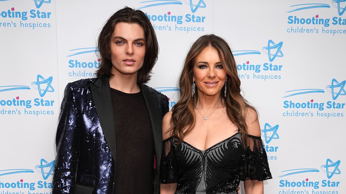 alert-–-elizabeth-hurley-wows-in-a-glamorous-black-gown-with-a-daring-thigh-high-split-as-she-joins-son-damian-at-the-shooting-star-ball