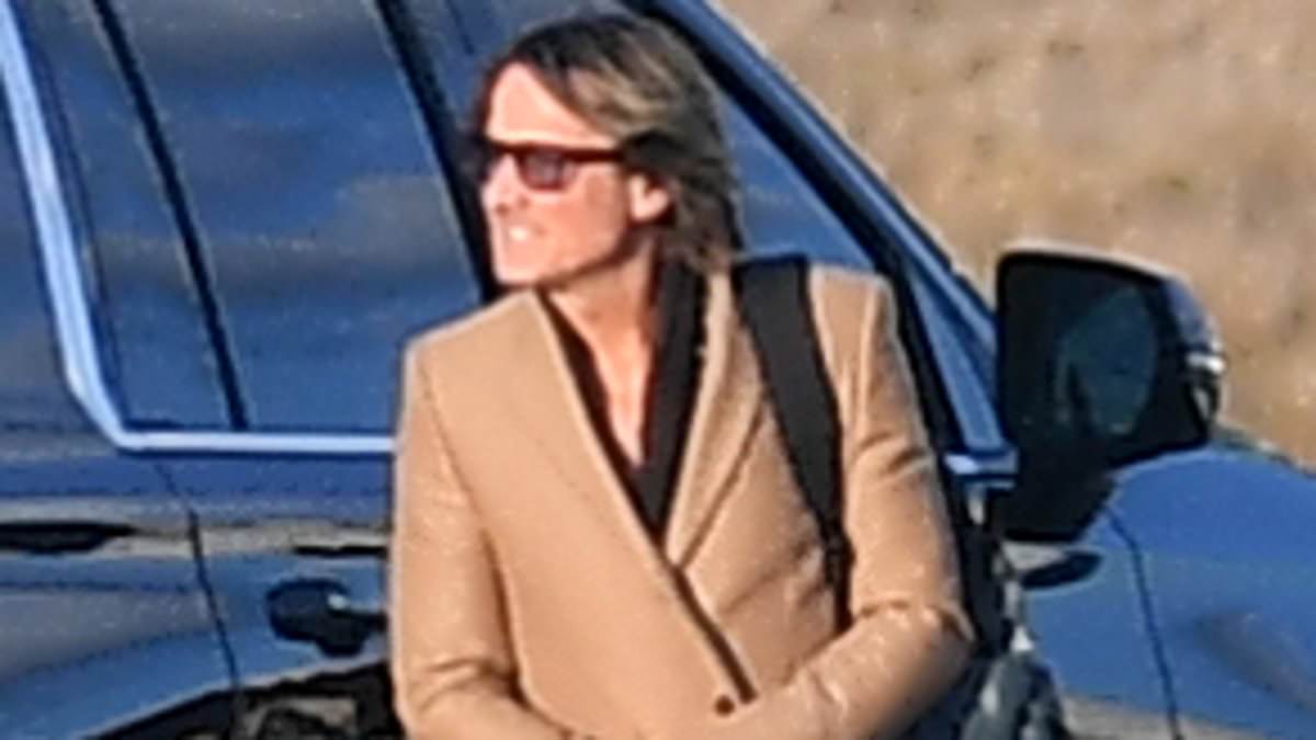 alert-–-camel-ain’t-your-colour!-keith-urban-rugs-up-in-bizarre-coat-and-platform-shoes-as-he-steps-out-of-a-private-jet-with-daughter-sunday-rose