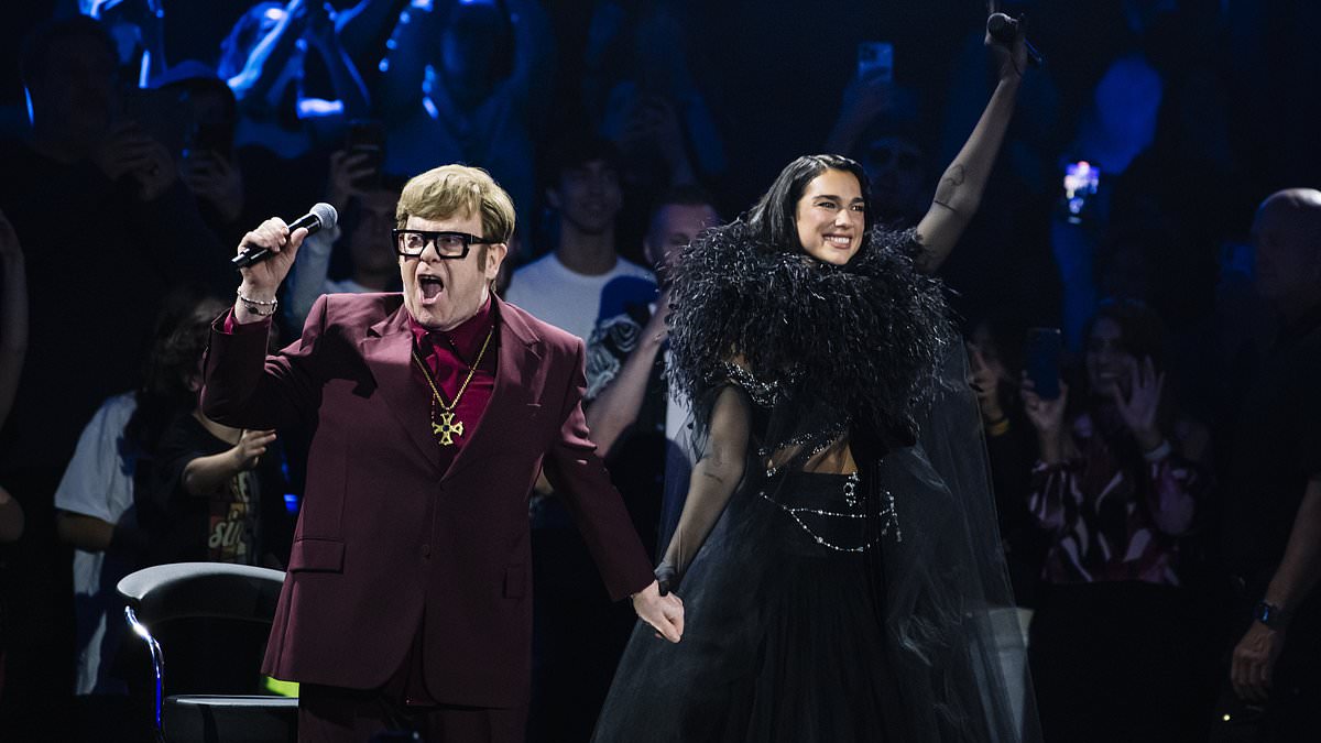 alert-–-elton-john’s-emotional-performance-with-dua-lipa-at-the-royal-albert-hall:-guided-off-stage,-struggling-to-stand-and-moving-little-–-a-powerful-reminder-of-his-health-struggles-and-vision-loss