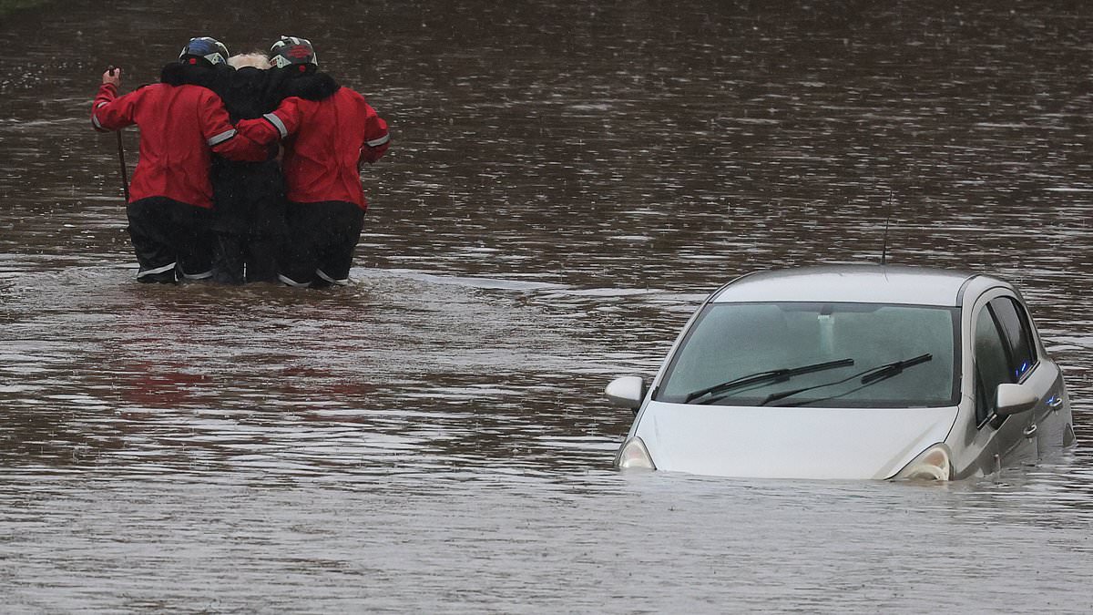 alert-–-moment-rescue-workers-wade-through-floods-and-haul-to-safety-elderly-man-stranded-in-waterlogged-car