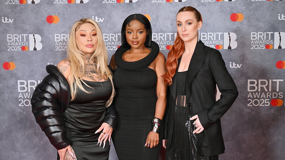 alert-–-the-sugababes’-mutya-buena-puts-on-a-very-leggy-display-in-a-thigh-high-split-black-gown-as-she-coordinates-with-her-bandmates-at-the-brit-awards