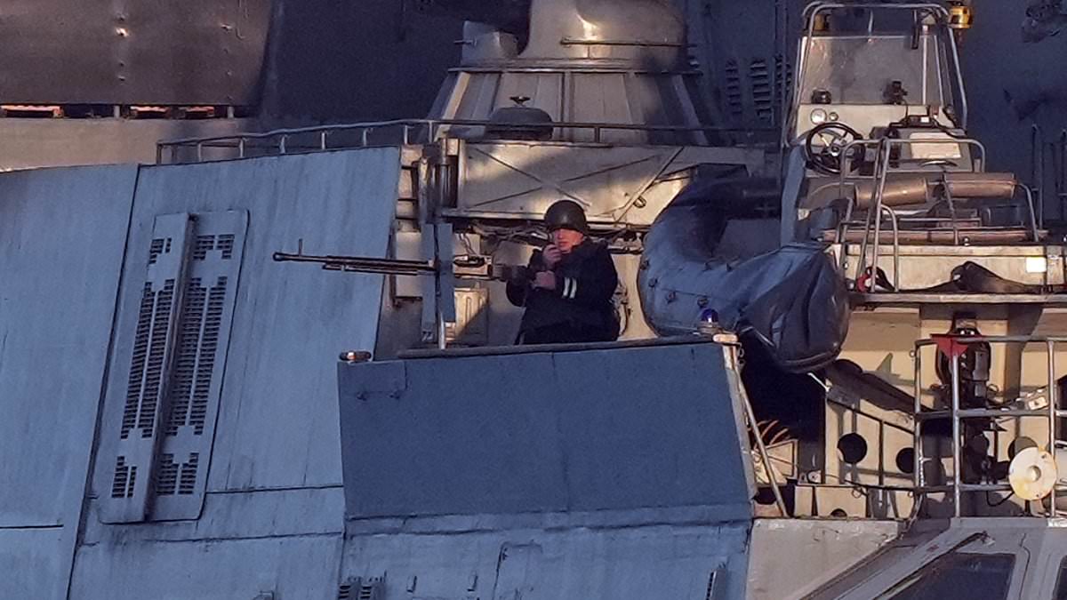 alert-–-chilling-moment-russian-navy-officer-brandishes-machine-gun-on-warship-in-the-english-channel-‘while-escorting-shipment-of-arms-bound-for-ukraine-frontline’