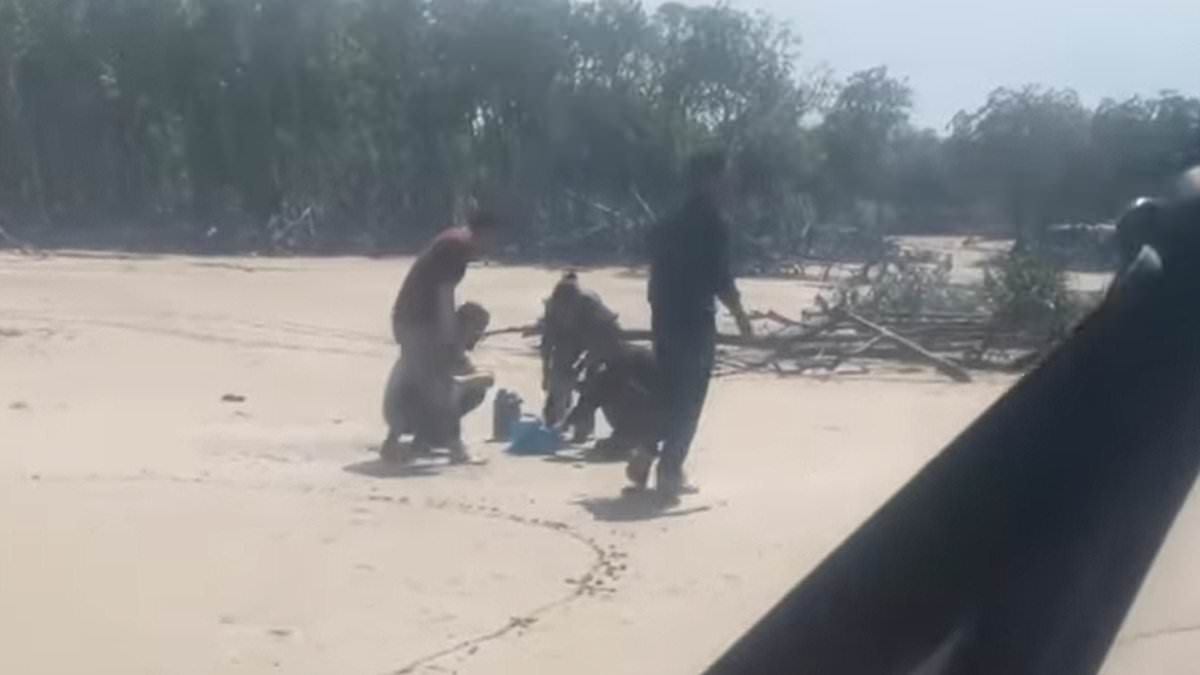 alert-–-dramatic-footage-shows-a-helicopter-land-near-five-stranded-men-believed-to-have-arrived-illegally-by-boat