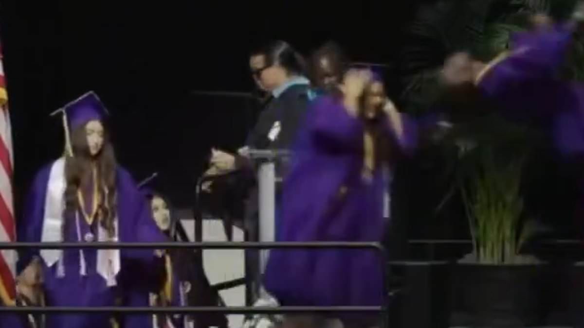 alert-–-high-school-graduate-kicks-another-student-in-the-face-as-he-pulls-a-surprise-stunt-while-accepting-diploma