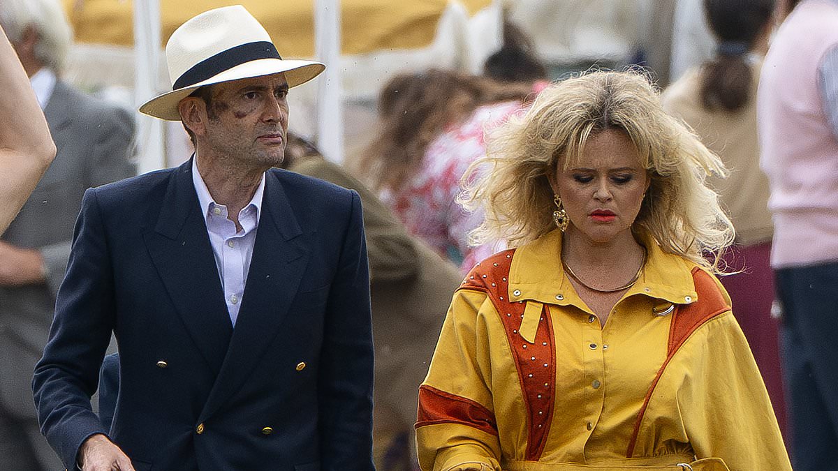 alert-–-emily-atack-rocks-giant-80s-inspired-hairstyle-and-vibrant-yellow-boilersuit-on-set-of-rivals-series-two-as-co-star-david-tennant-makes-shock-return