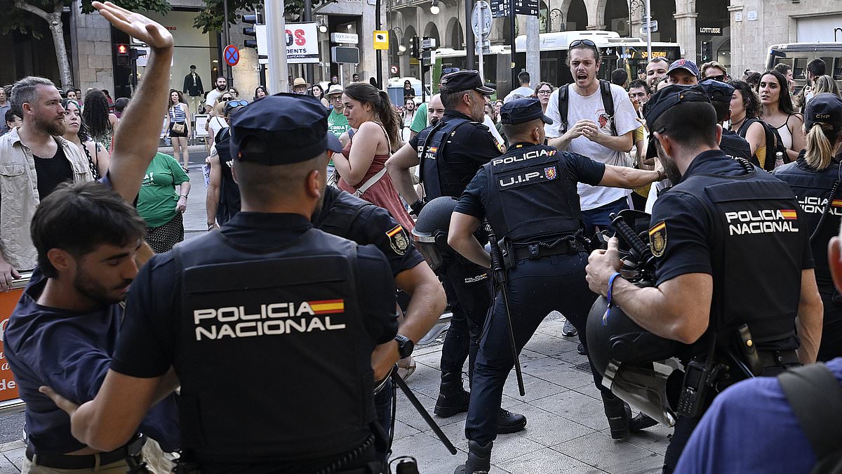 alert-–-shocking-moment-police-scuffle-with-anti-tourist-protesters-yelling-abuse-and-waving-an-axe-at-diners-in-a-majorca-restaurant-during-latest-demonstrations-aimed-at-holidaymakers
