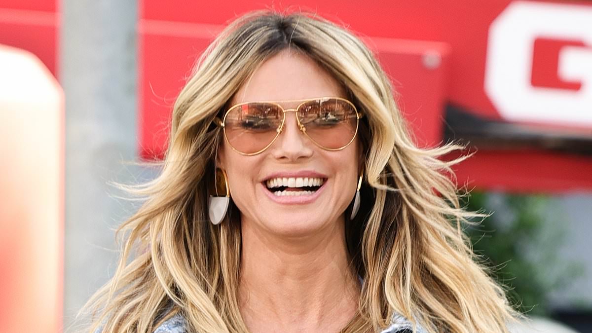 alert-–-heidi-klum-shows-off-her-midriff-in-a-skimpy-bikini-top-and-double-denim-as-celebrates-her-calzedonia-billboard
