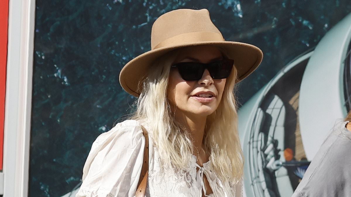 alert-–-holly-willoughby-leads-the-stars-letting-their-hair-down-at-glastonbury-as-she-treats-herself-to-a-drink-after-taking-a-helicopter-to-the-festival