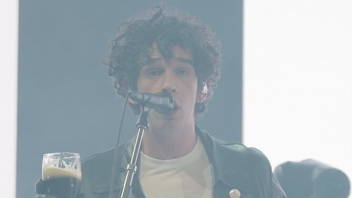 alert-–-matty-healy-smokes-a-cigarette-and-drinks-a-pint-of-guinness-before-calling-himself-his-generation’s-‘best-songwriter’-as-he-takes-to-the-stage-for-the-1975’s-glastonbury-headliner-set