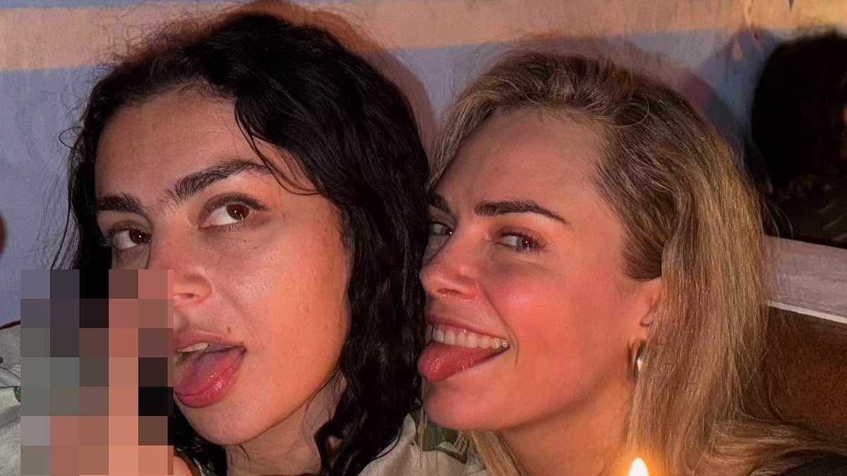 alert-–-charli-xcx-puts-on-a-very-leggy-display-in-black-hotpants-and-a-crop-top-as-she-parties-with-cara-delevingne-at-glastonbury