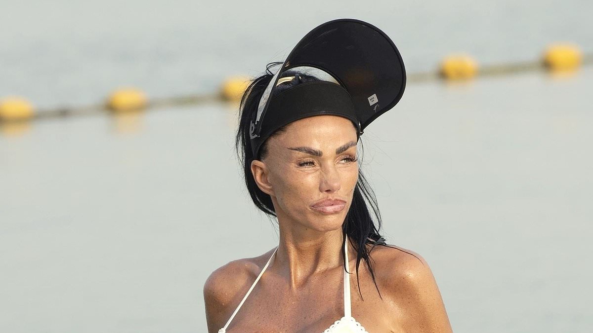 alert-–-katie-price-flaunts-her-assets-in-a-skimpy-butter-yellow-bikini-and-wears-a-bizarre-huge-mirror-visor-while-on-the-beach-in-dubai