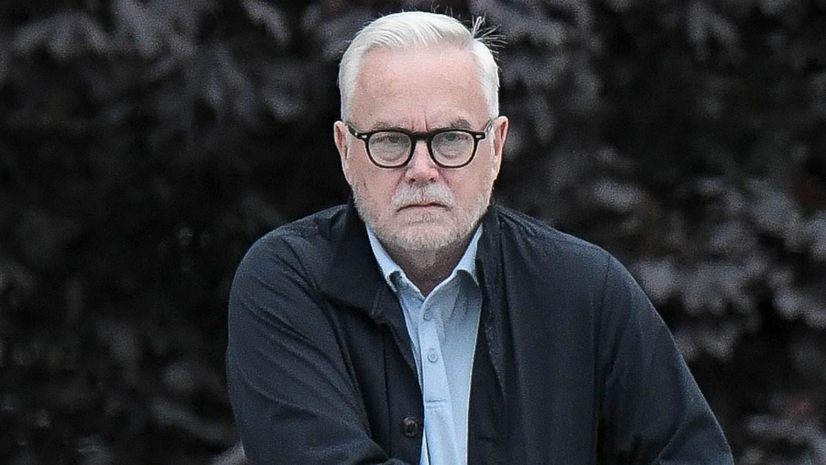 alert-–-huw-edwards-steps-out-with-mini-bottles-of-prosecco-to-celebrate-his-64th-birthday-in-swansea
