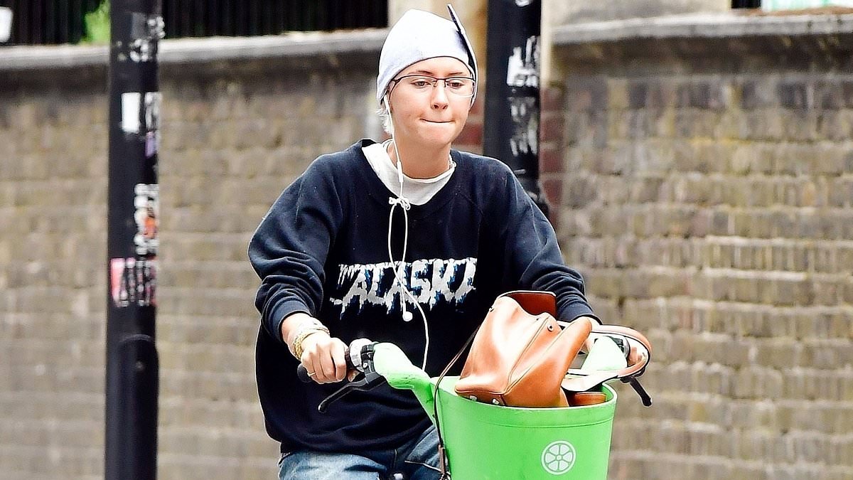 alert-–-iris-law-cuts-a-casual-figure-in-a-navy -sweatshirt-as-she-braves-busy-london-traffic-on-a-punctured-lime-bike