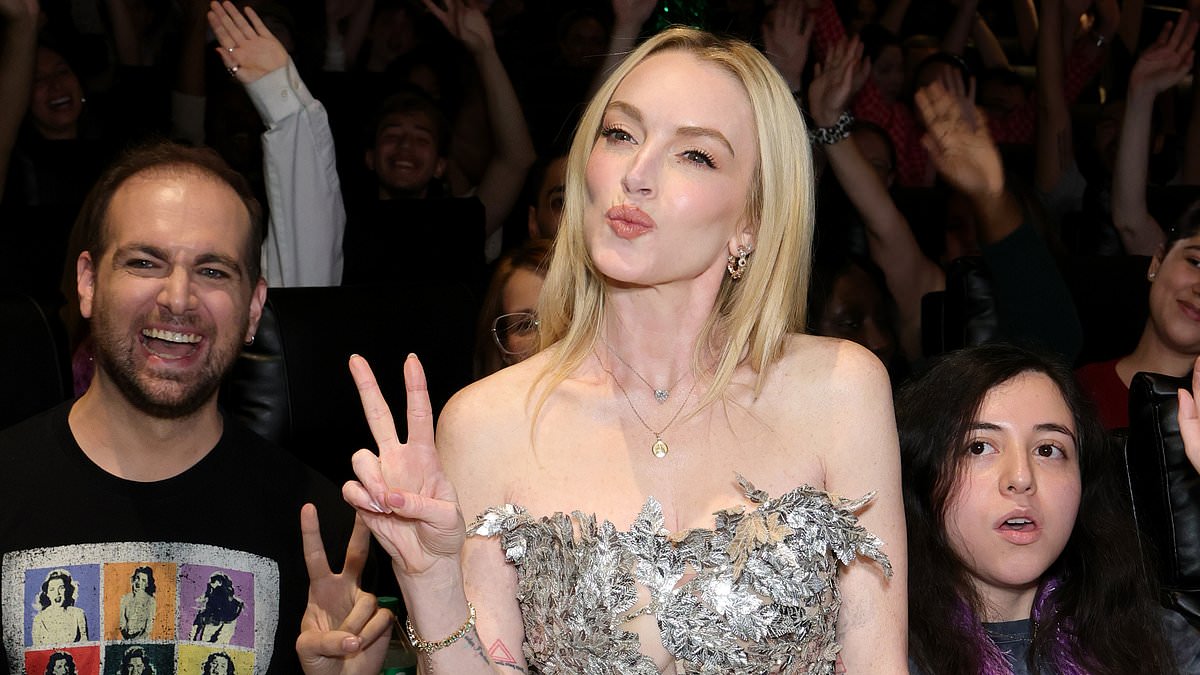 alert-–-lindsay-lohan-turns-heads-in-silver-strapless-top-as-she-stuns-fans-with-surprise-appearance-at-freakier-friday-theatre-showing-in-nyc